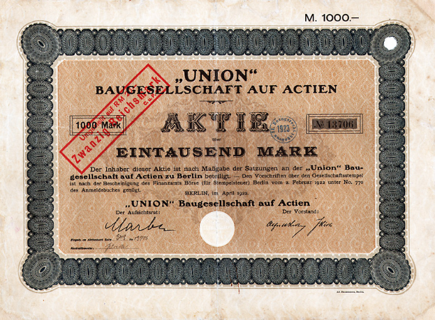 Ein alter deutscher Bankschein mit einem roten Stempel und Text, der darauf hinweist, dass es ein Aktienzertifikat ist.