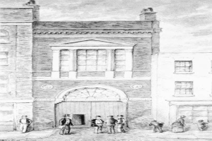 Schwarze-Zeichnung-eines-Gebäudes-mit-einer-Gruppe-Menschen-vor-dem-Gebäude-unterzeichnet-"1892-die-erste-Feuerwache"-unten.